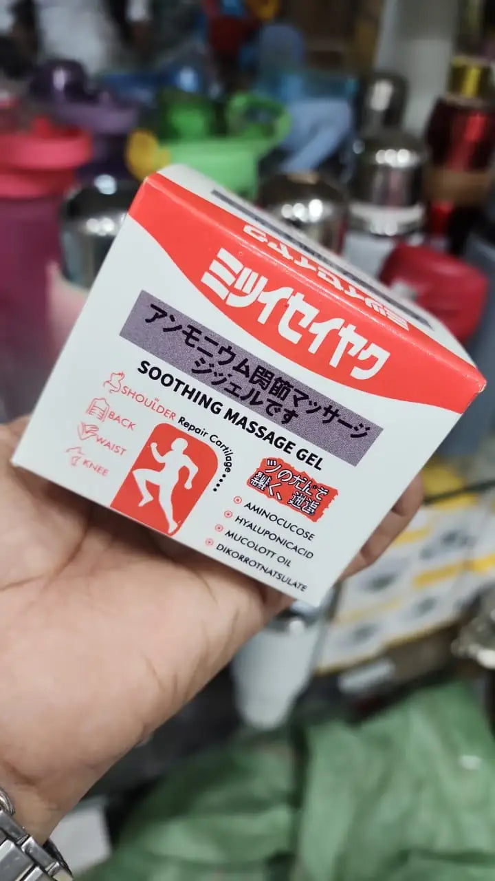 Hand holding Japanese soothing massage gel box showing shoulder, back, waist, and knee pain relief benefits